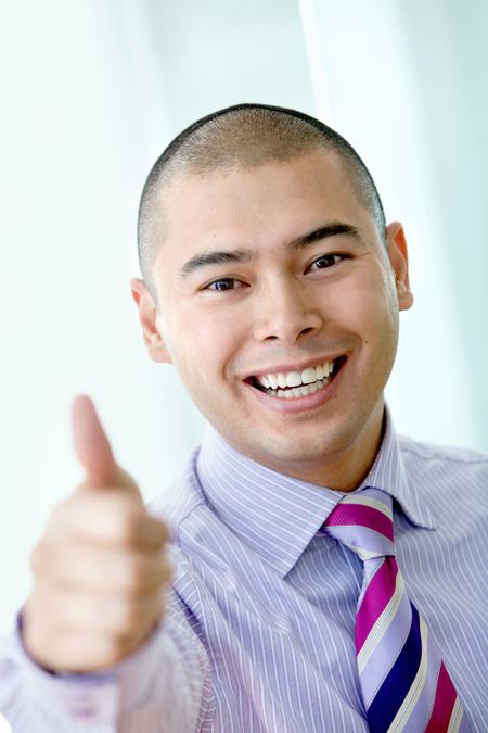 business man smiling with thumb up at the office