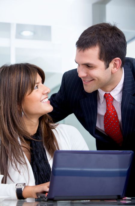 business partners on a laptop computer in an office