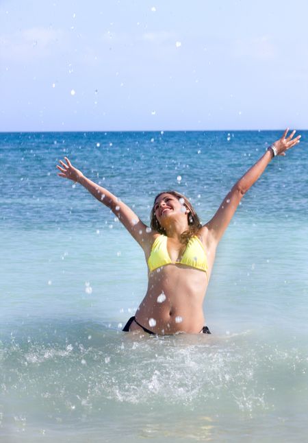 freedom woman with arms up having fun at the beach