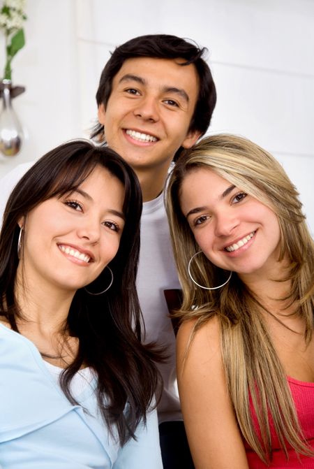 man and two girls smiling and looking happy at home