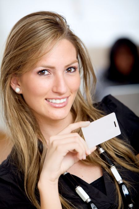 Beautiful woman with a business card at an office