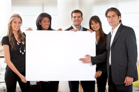 Business group holding a banner at an office