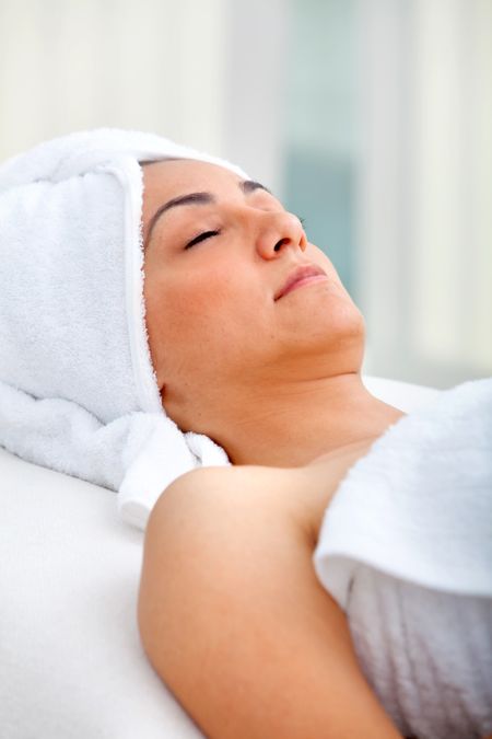 Woman at a spa relaxing with a towel on her head