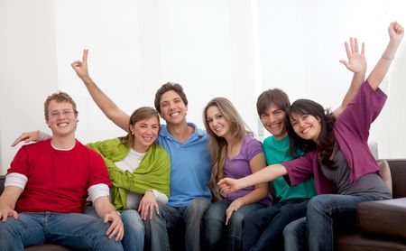 Happy group of young people sitting on a sofa