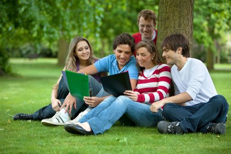 Group of people studying outdoors and smiling