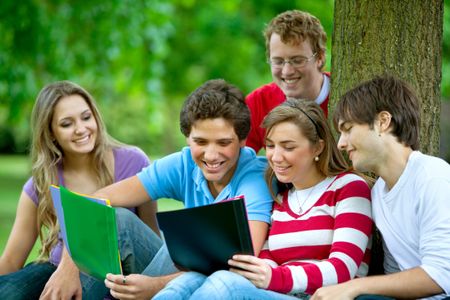 Group of people studying outdoors and smiling