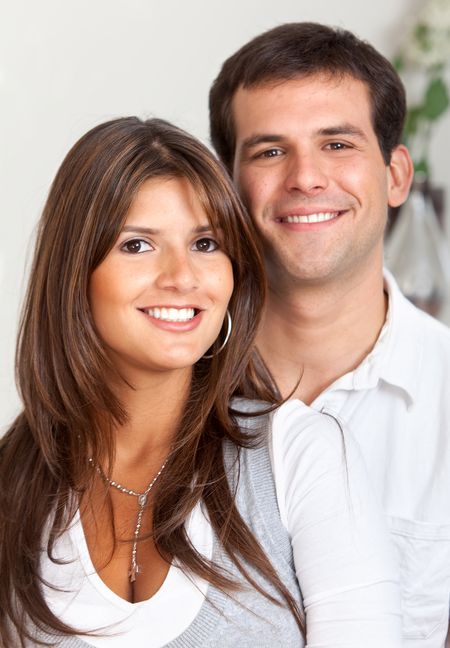 Beautiful loving couple portrait at home smiling