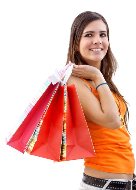 Beautiful girl with shopping bags smiling isolated