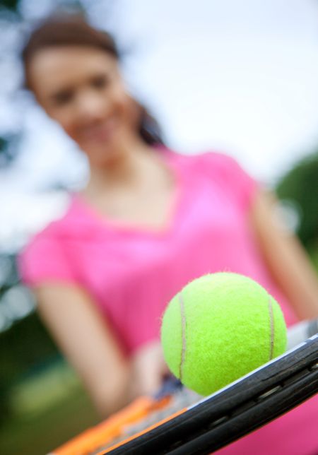 Female tennis player with a racket and a ball