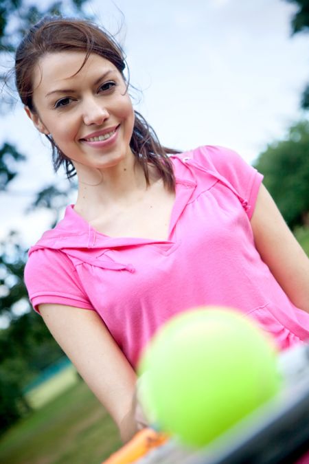 Female tennis player with a racket and a ball