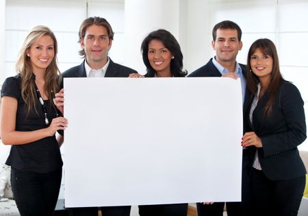 Business group holding a banner at an office