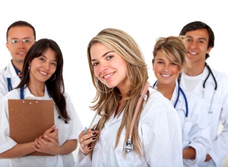 female doctor holding a stethoscope with her team behind her - isolated