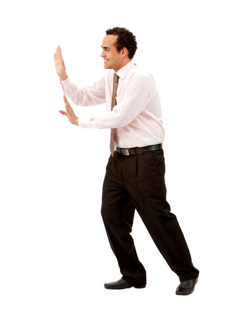 Happy business man pushing something imaginary isolated on white