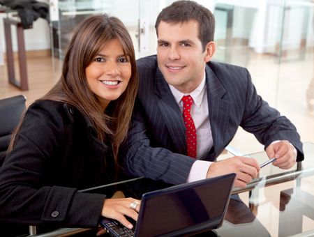 business partners on a laptop computer in an office