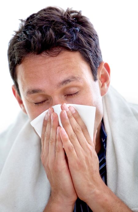 Sick man sneezing isolated over a white background