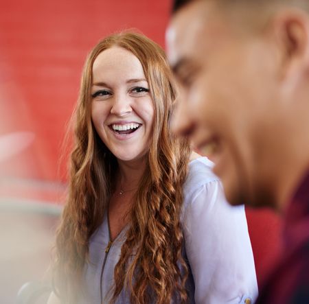Unposed group of creative business people in an open concept office brainstorming their next project.