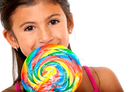 Girl eating a colorful candy isolated over a white background