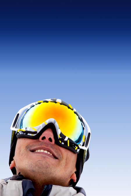 Man portrait with ski goggles outdoors and smiling