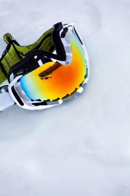 Ski goggles layed on snow - sports equipment