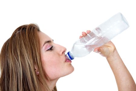 Woman driking water from a bottle isolated over a white background