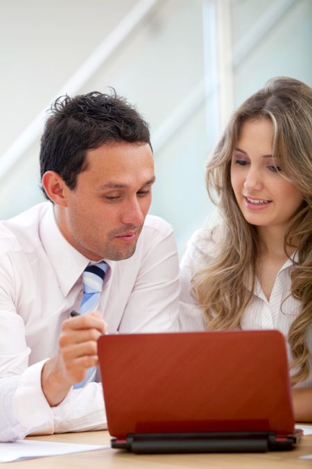 Business couple working on a laptop ath the office