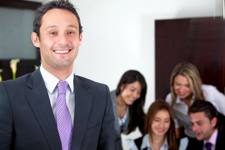 business man at the office with a group behind