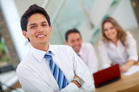 Young business man smiling at the office