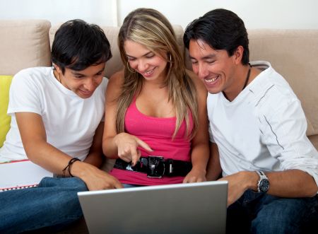 Group of students with a laptop at home