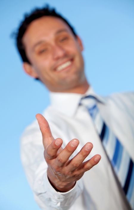 Business man extending his hand to handshake outdoors