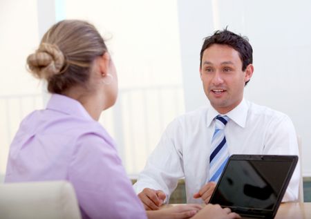 Business couple working on a laptop at the office