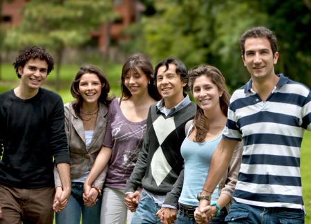 happy group of friends smiling outdoors