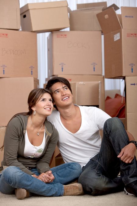 Couple portrait with boxes moving to a new home