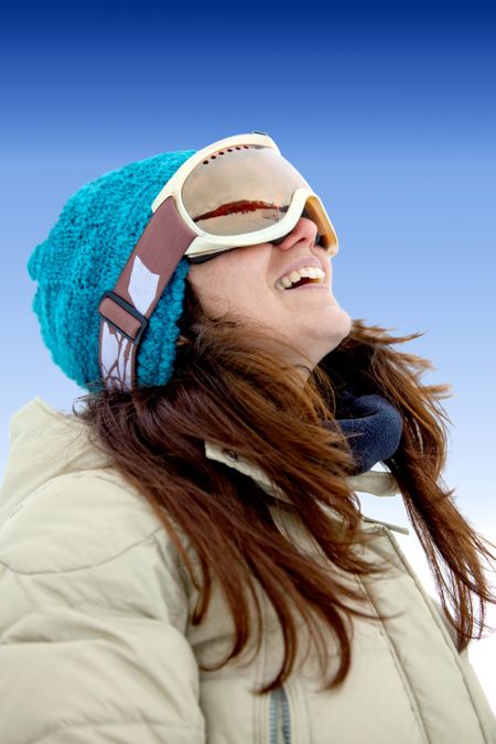 female skier smiling and wearing ski glasses