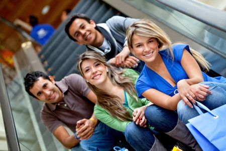 Group of friends shopping in a mall with some bags