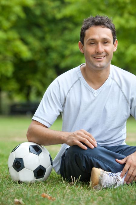 Man with a football in a park