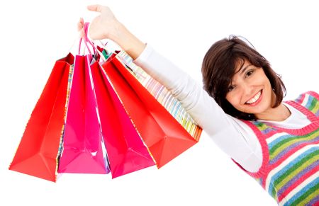 Happy woman with shopping bags isolated on white
