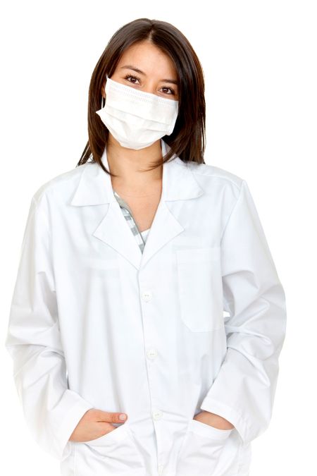 Female doctor with a facemask isolated over a white background