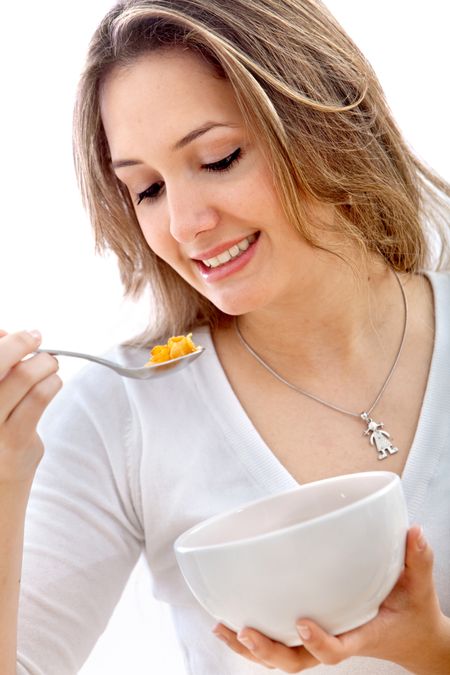 Woman eating cereals isolated over a white background