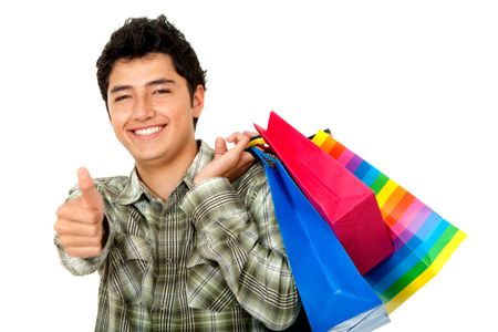 Happy man shopping with his thumbs up isolated on white
