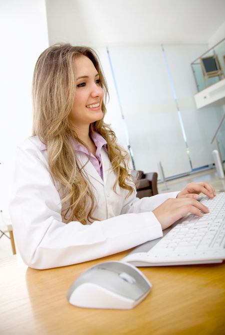 Female doctor at the office working on the computer