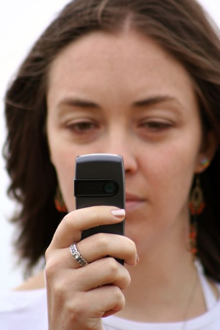 girl with camera mobile phone - focus on phone