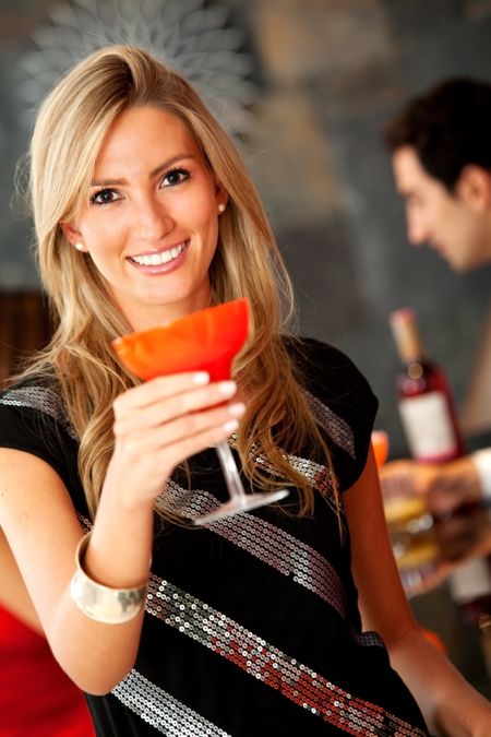 Beautiful woman at the bar with a cocktail
