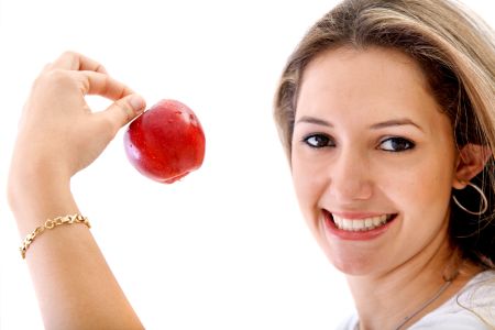 casual woman with a red apple over a white background