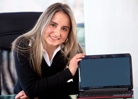 business woman displaying a laptop computer in her office