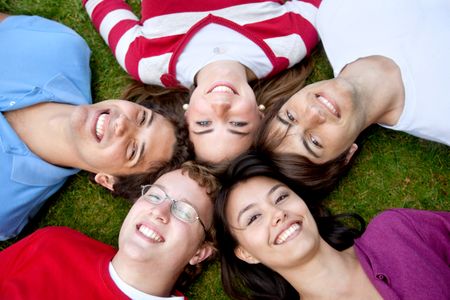 happy group of friends with their heads together on the floor