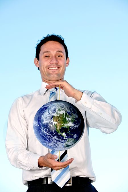 Business man smiling and holding globe in his hands