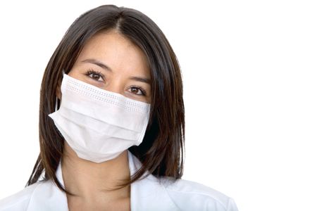 Female doctor with facemask isolated over a white background