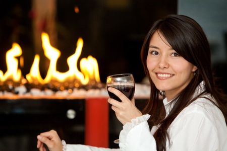 Woman at a romantic dinner with a glass of wine
