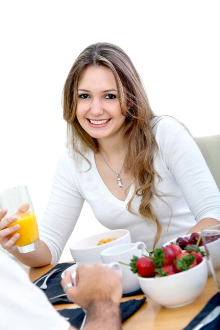 Beautiful woman eating her breakfast and smiling