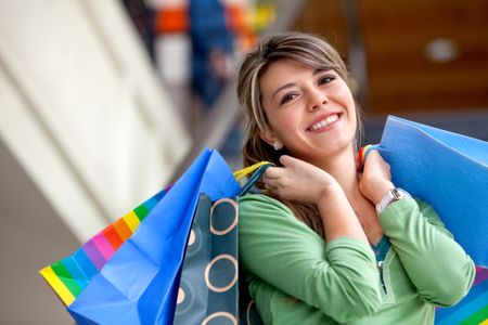 Beautiful shopping woman with bags at a mall